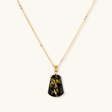 18k gold-plated necklace and earrings with green amber pendants featuring golden inclusions on cream background