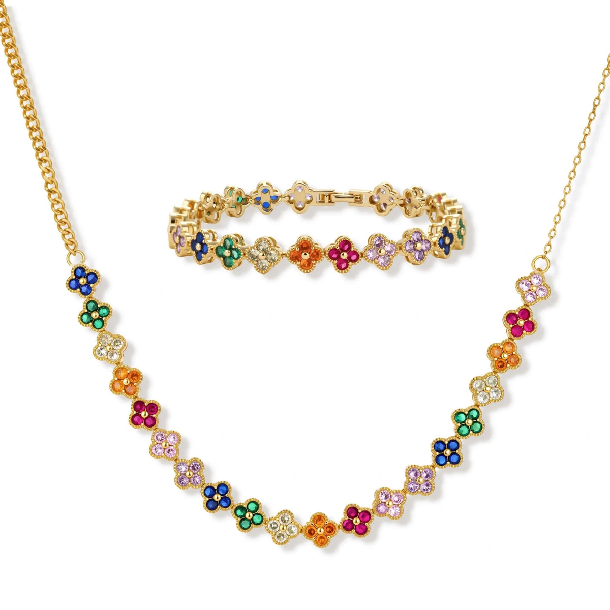 Colorful four-leaf clover jewelry set with rainbow cubic zirconia stones in gold-plated setting on white background
